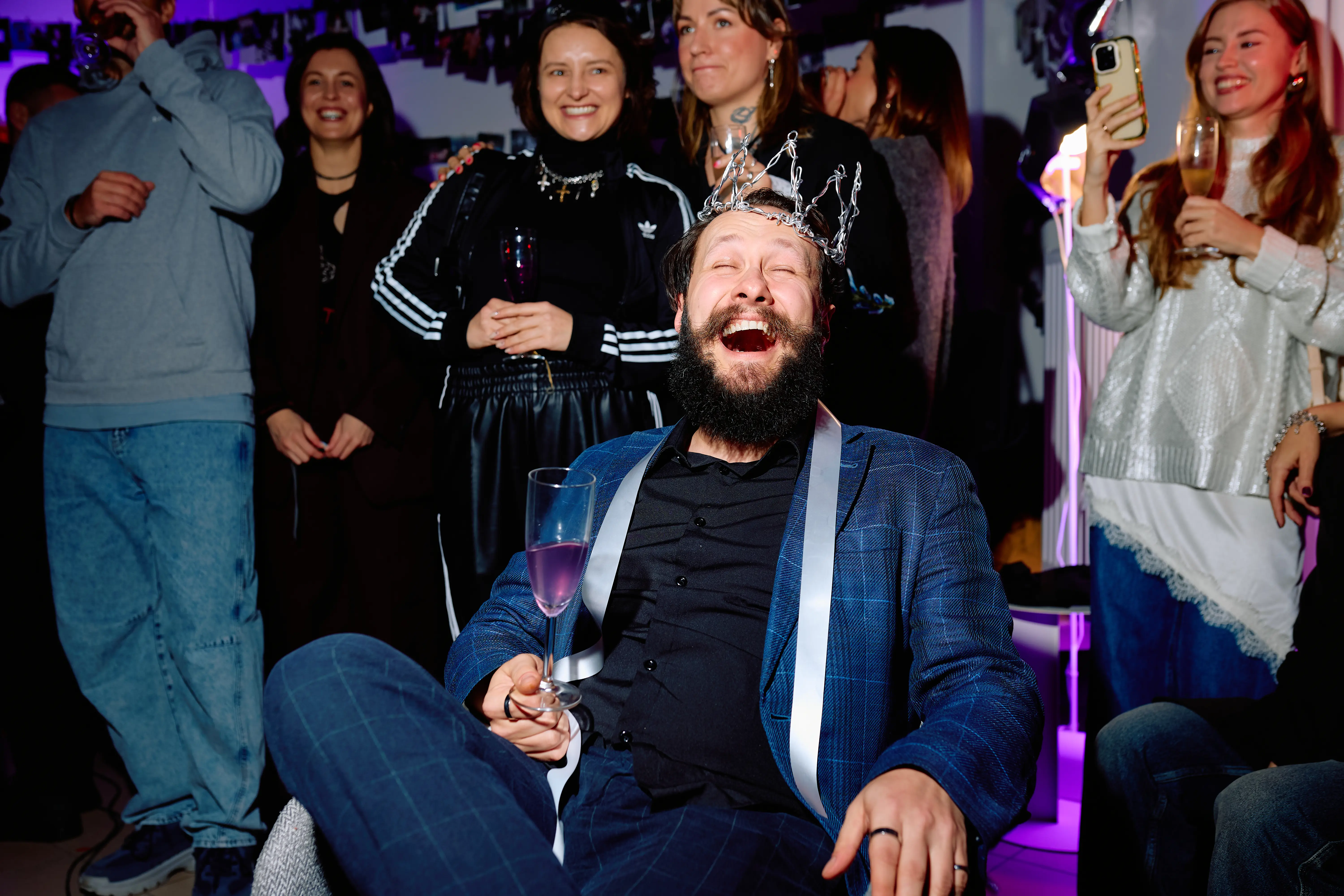 Ivan Smolyar, known as Johnny Cosmic, laughing in a foil crown during the surprise exhibition organised for him in Warsaw